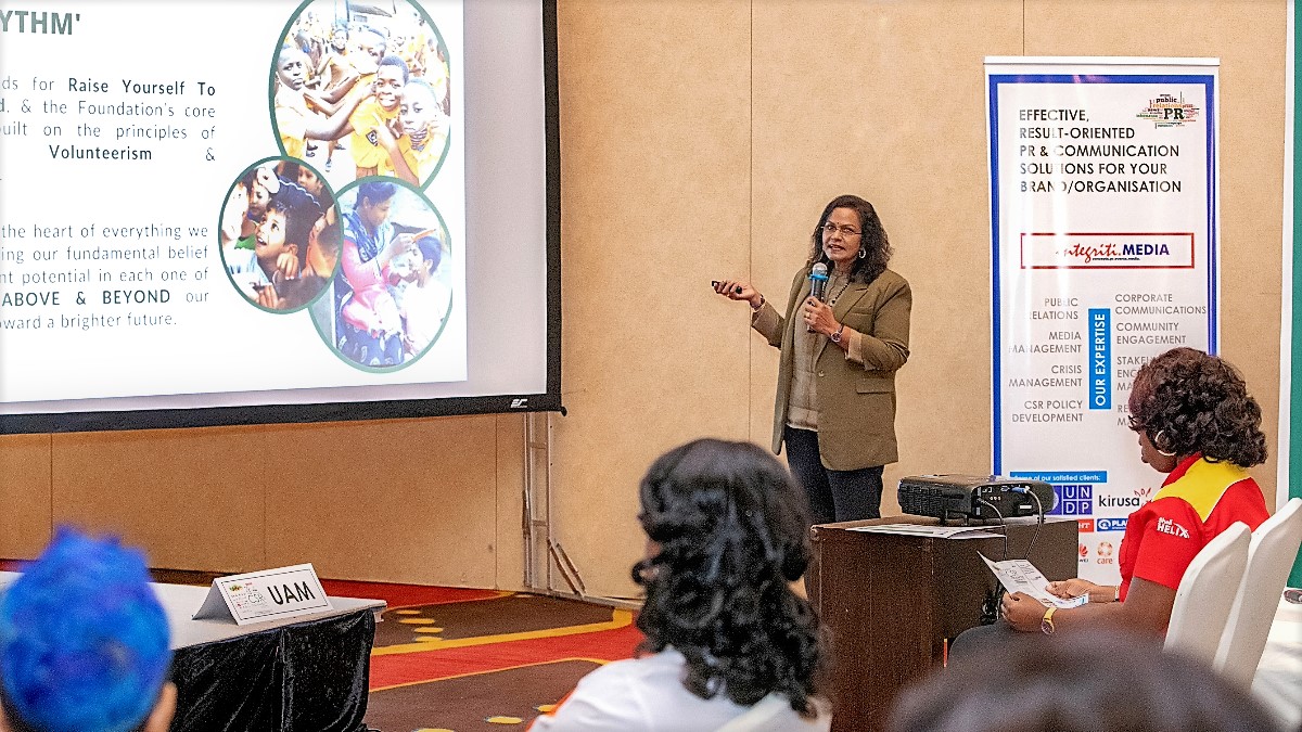 Santhi Periasamy presenting RYTHM's projects to an engaged audience.