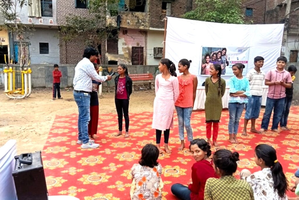 Young girls and boys take their turns to speak in front of peers.