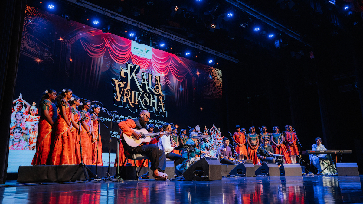 Musicians and a choir perform on stage at the Kala Vriksha event.