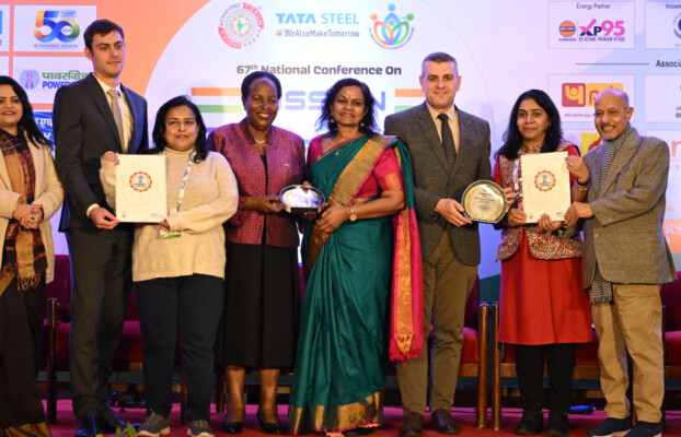 A group of individuals holding awards and certificates.